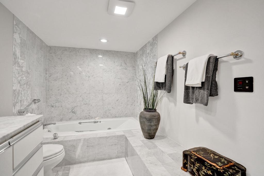 501 North Riverside Drive, Unit 203 Pompano Beach, FL 33062 - Photo 33 of 63 a bathroom with a granite countertop sink a toilet a mirror and shower