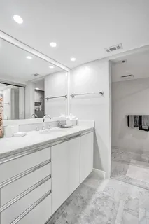 a view of a hallway with two couch and a view of bathroom