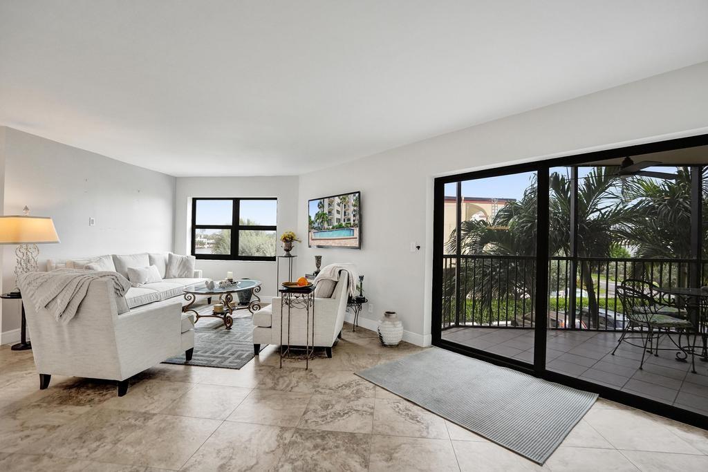 501 North Riverside Drive, Unit 203 Pompano Beach, FL 33062 - Photo 7 of 63 a living room with furniture and large windows