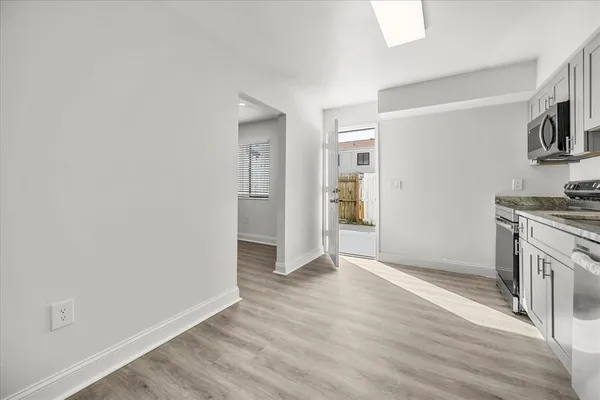 wooden floor in an empty room with a fireplace