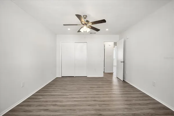 a view of an empty room with wooden floor