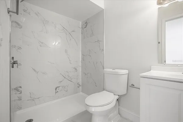 a bathroom with a toilet and a bathtub