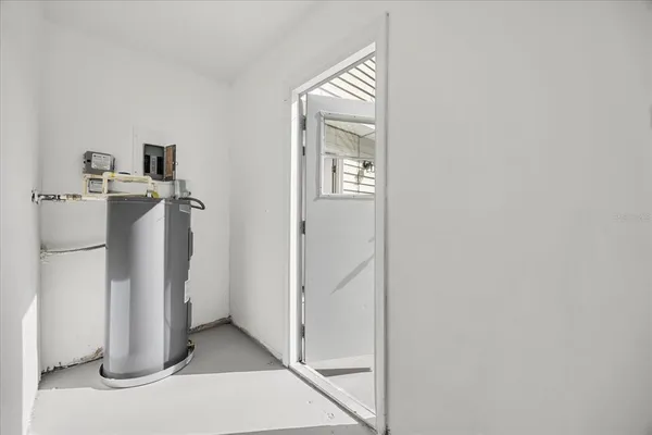 a view of a hallway with closet and front door