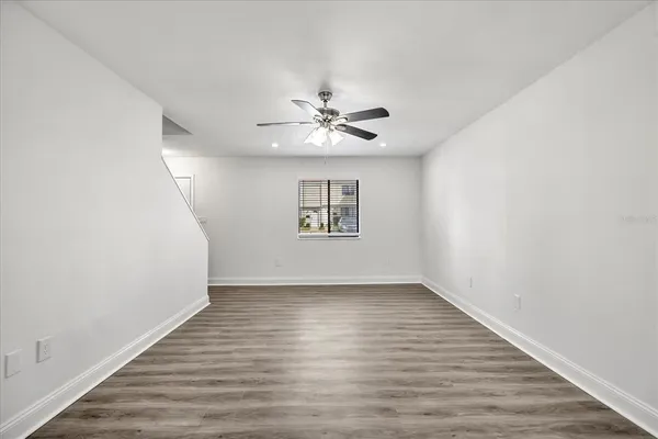 wooden floor in an empty room with a window