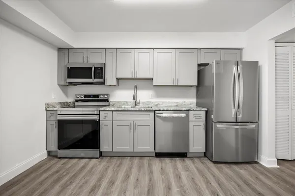 a kitchen with a refrigerator stove and microwave