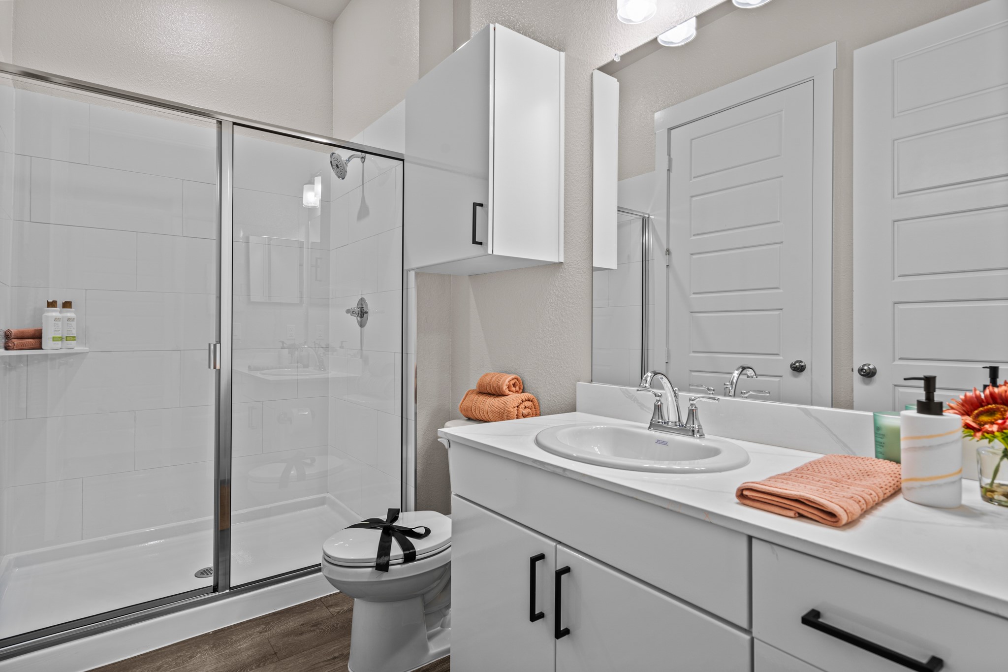 865 Limmer Loop, Unit 1105 Hutto, TX 78634 - Photo 14 of 32 a bathroom with a sink a toilet and shower