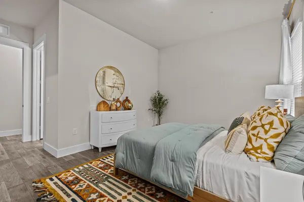 a bedroom with a bed and a chandelier
