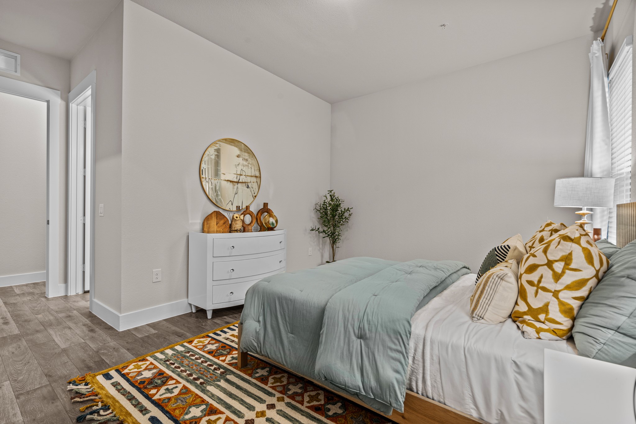865 Limmer Loop, Unit 1105 Hutto, TX 78634 - Photo 16 of 32 a bedroom with a bed and a chandelier