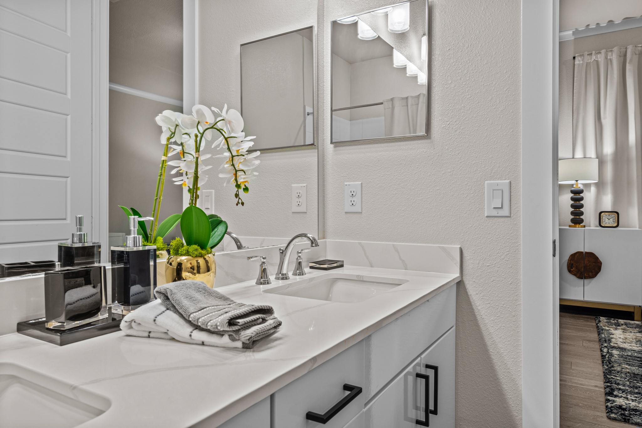 865 Limmer Loop, Unit 1105 Hutto, TX 78634 - Photo 28 of 32 a bathroom with a sink and a mirror