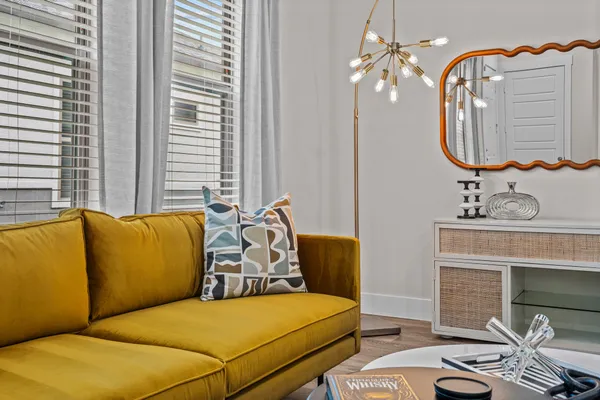 a bedroom with bed and a mirror