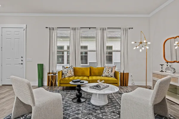 a living room with furniture and a large window