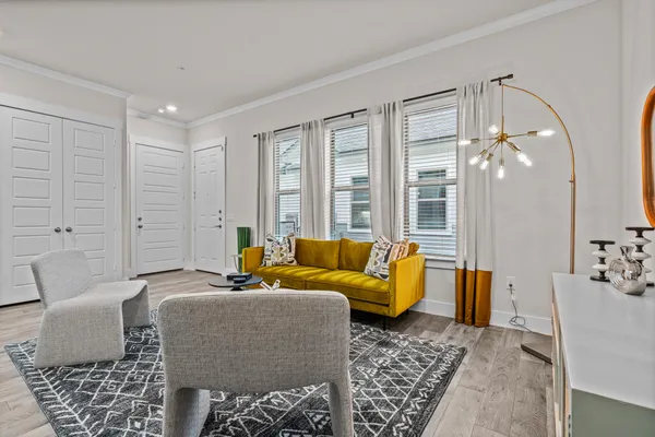 a living room with furniture and wooden floor