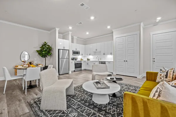 a living room with furniture and kitchen view