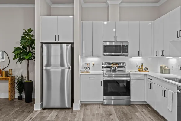 a kitchen with stainless steel appliances a stove cabinets and a refrigerator