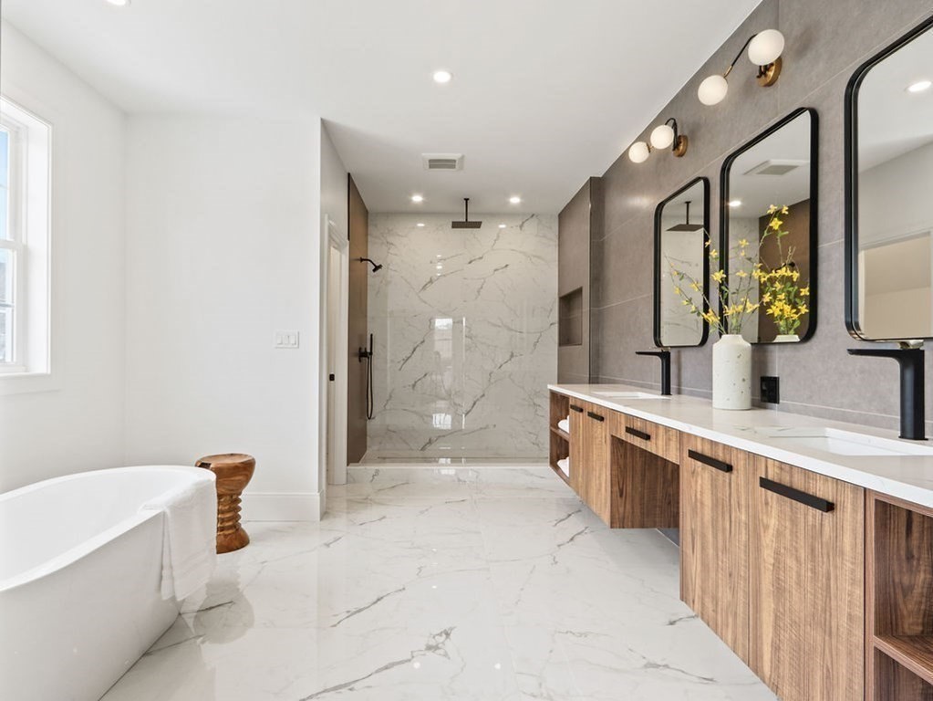 48 Valley View Road Waltham, MA 02452 - Photo 14 of 29 a large bathroom with a tub a sink a mirror a shower and vanity