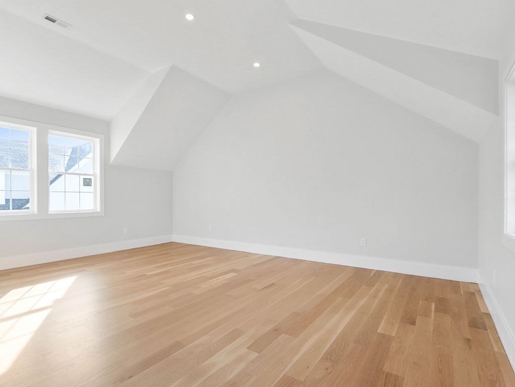48 Valley View Road Waltham, MA 02452 - Photo 21 of 29 an empty room with wooden floor and windows