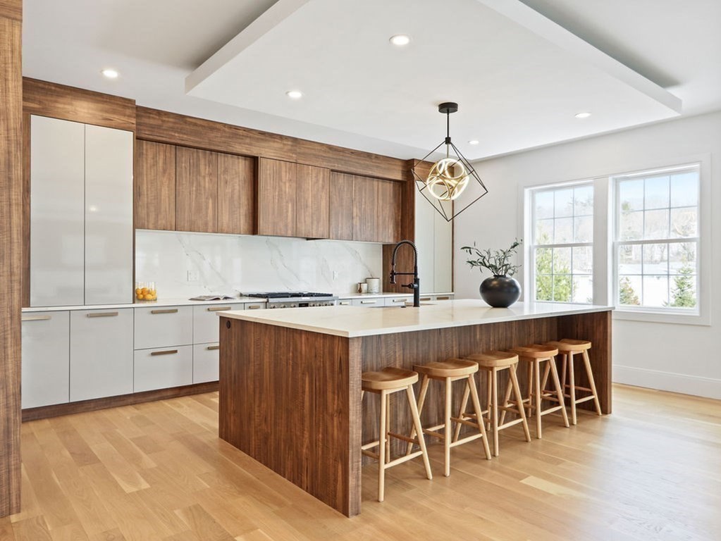 48 Valley View Road Waltham, MA 02452 - Photo 3 of 29 a kitchen with a stove a sink dishwasher and a refrigerator with wooden floor