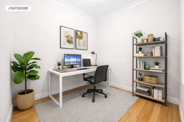 a bedroom with a bed and a table with a bookshelf