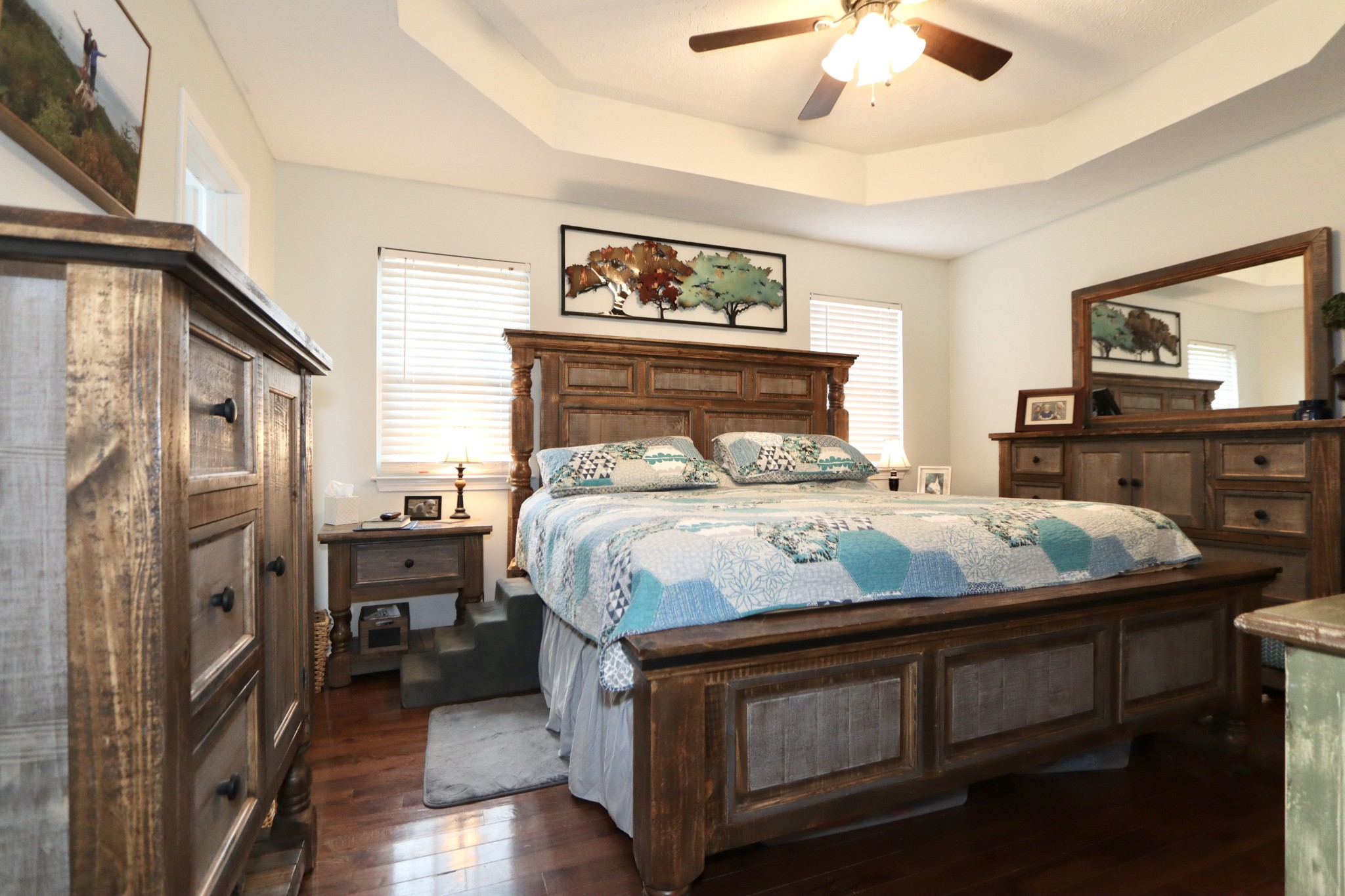 972 Williamson County Line Road Fairview, TN 37062 - Photo 13 of 68 a bed sitting in a bedroom next to a cabinet with a flat tv screen and dresser