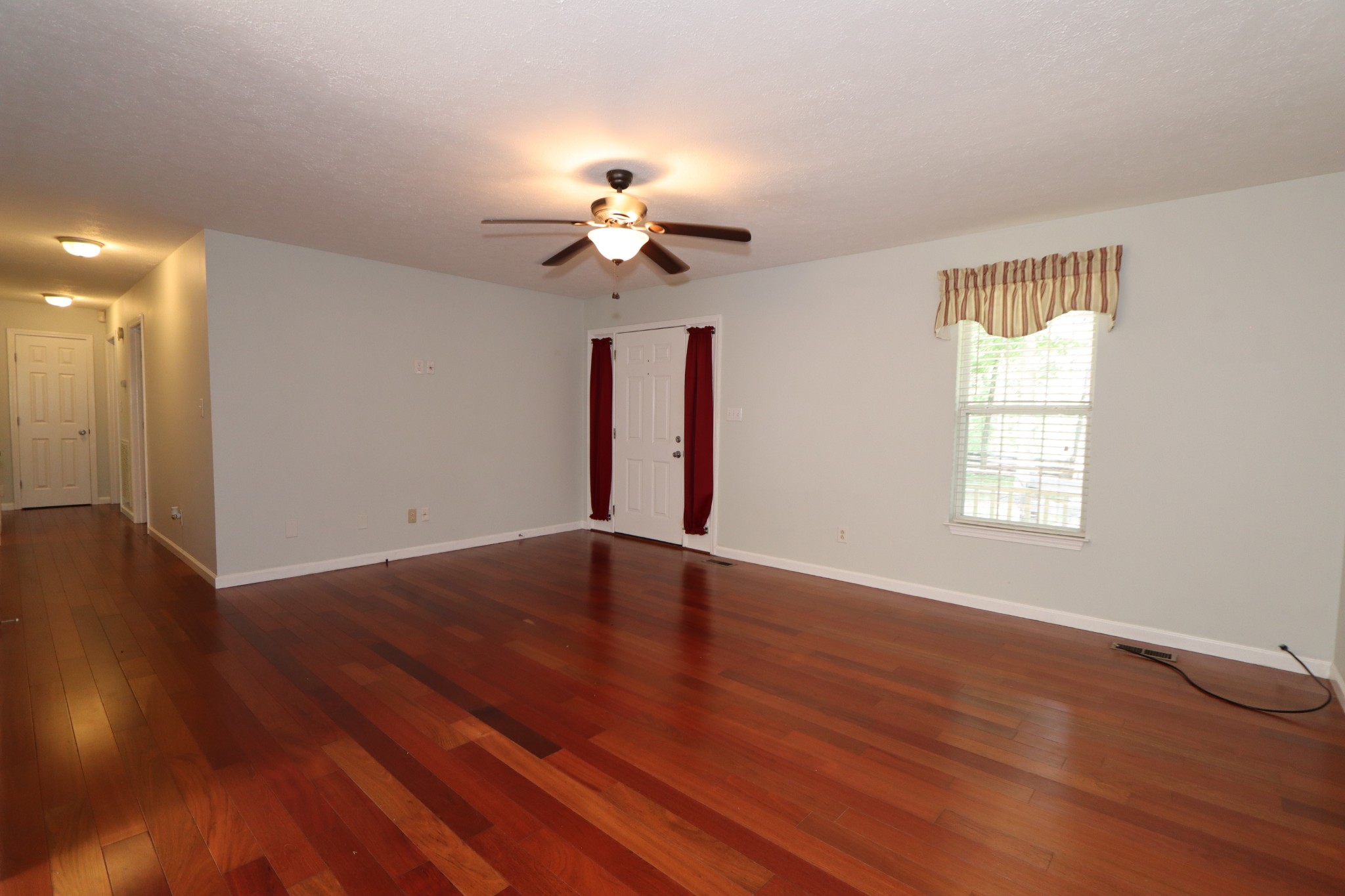 972 Williamson County Line Road Fairview, TN 37062 - Photo 50 of 68 a view of an empty room with wooden floor and a window