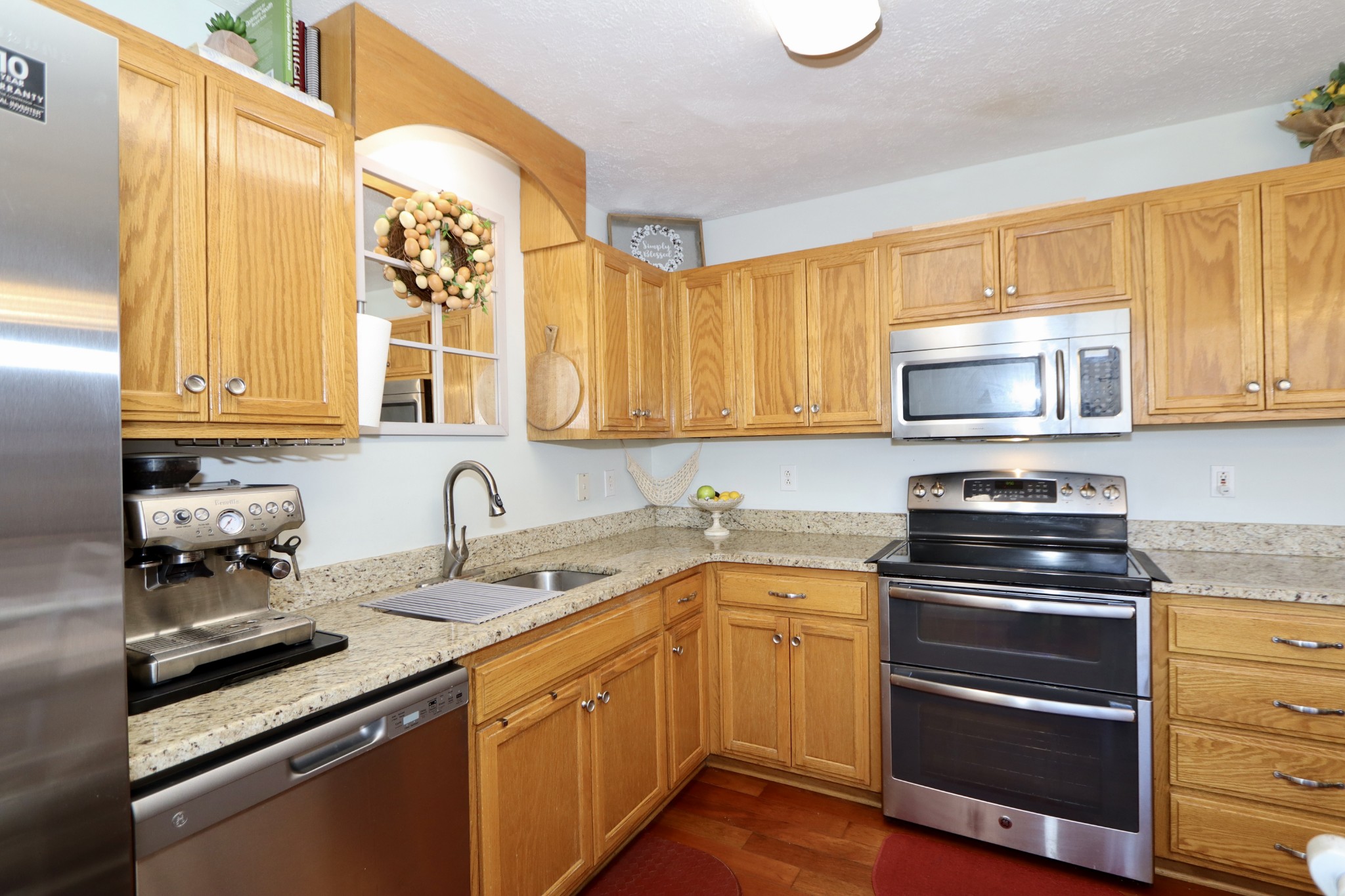 972 Williamson County Line Road Fairview, TN 37062 - Photo 8 of 68 a kitchen with stainless steel appliances granite countertop a stove a sink and a microwave