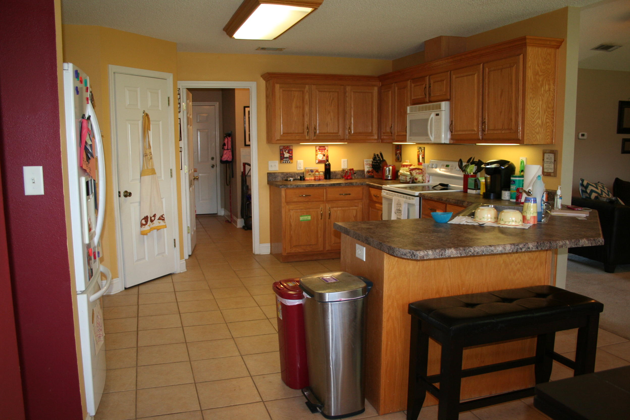 4888 Jennifer Lane Pace, FL 32571 - Photo 7 of 10 a kitchen with stainless steel appliances granite countertop a stove refrigerator sink and cabinets