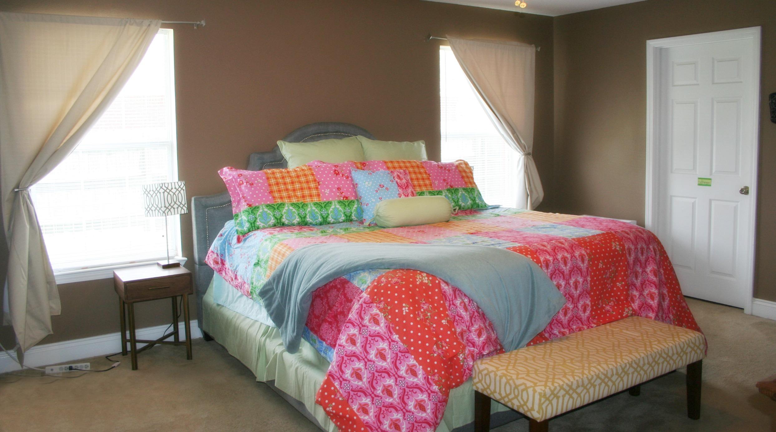4888 Jennifer Lane Pace, FL 32571 - Photo 8 of 10 a bedroom with a bed chair and a window