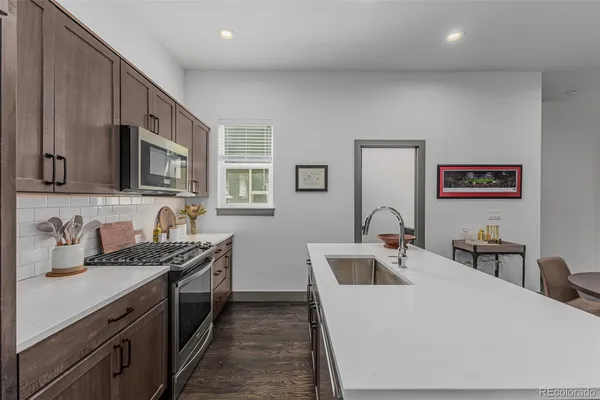 a kitchen that has a sink and a stove in it