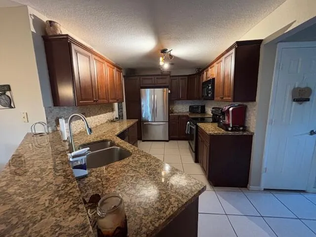 a kitchen with refrigerator and cabinets