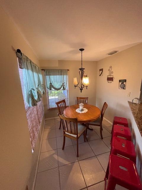 1003 Ocean Dunes Circle Jupiter, FL 33477 - Photo 13 of 33 a view of a dining room with furniture and wooden floor