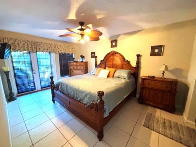 a large bedroom with a bed and a chandelier