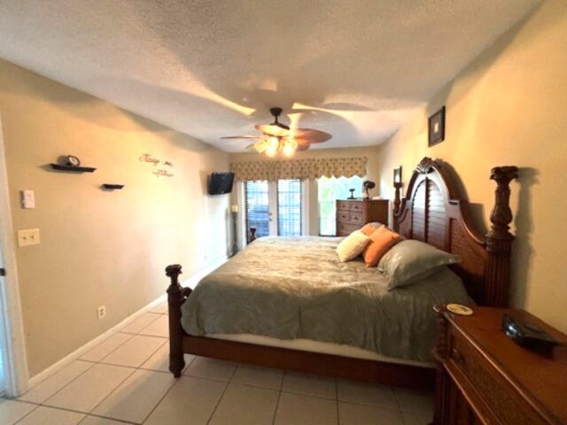 1003 Ocean Dunes Circle Jupiter, FL 33477 - Photo 16 of 33 a bedroom with a bed and a dresser