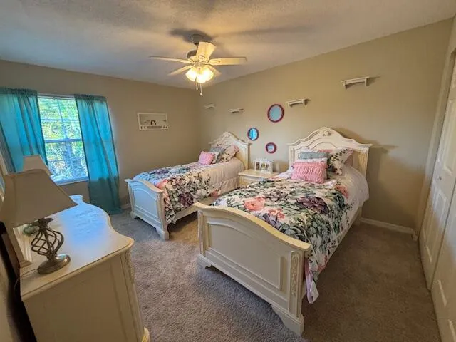 a bedroom with two beds and a chandelier