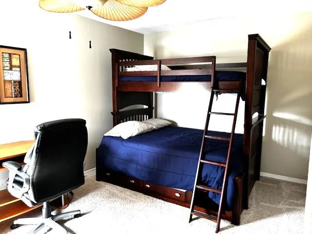 a view of a workspace with furniture and lamp