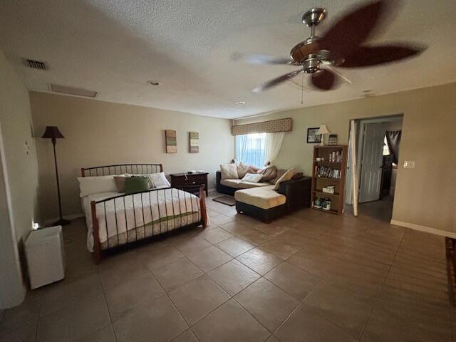 1003 Ocean Dunes Circle Jupiter, FL 33477 - Photo 24 of 33 a bedroom with furniture and a chandelier