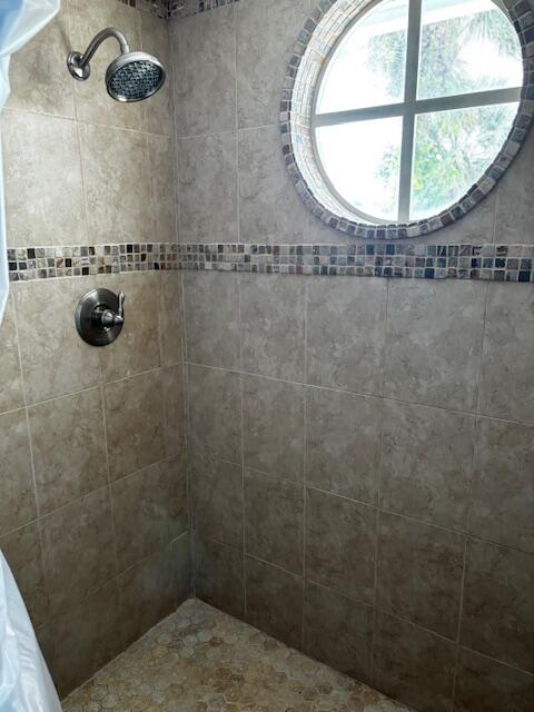 1003 Ocean Dunes Circle Jupiter, FL 33477 - Photo 26 of 33 a bathroom with a sink and a mirror