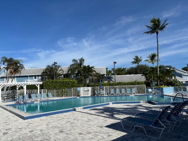 1003 Ocean Dunes Circle Jupiter, FL 33477 - Photo 30 of 33 a view of a chairs and table on the terrace