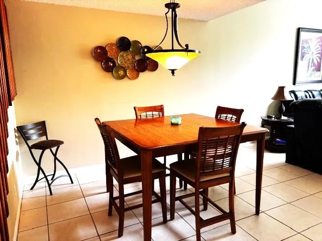 a dining room table chairs and a chandelier
