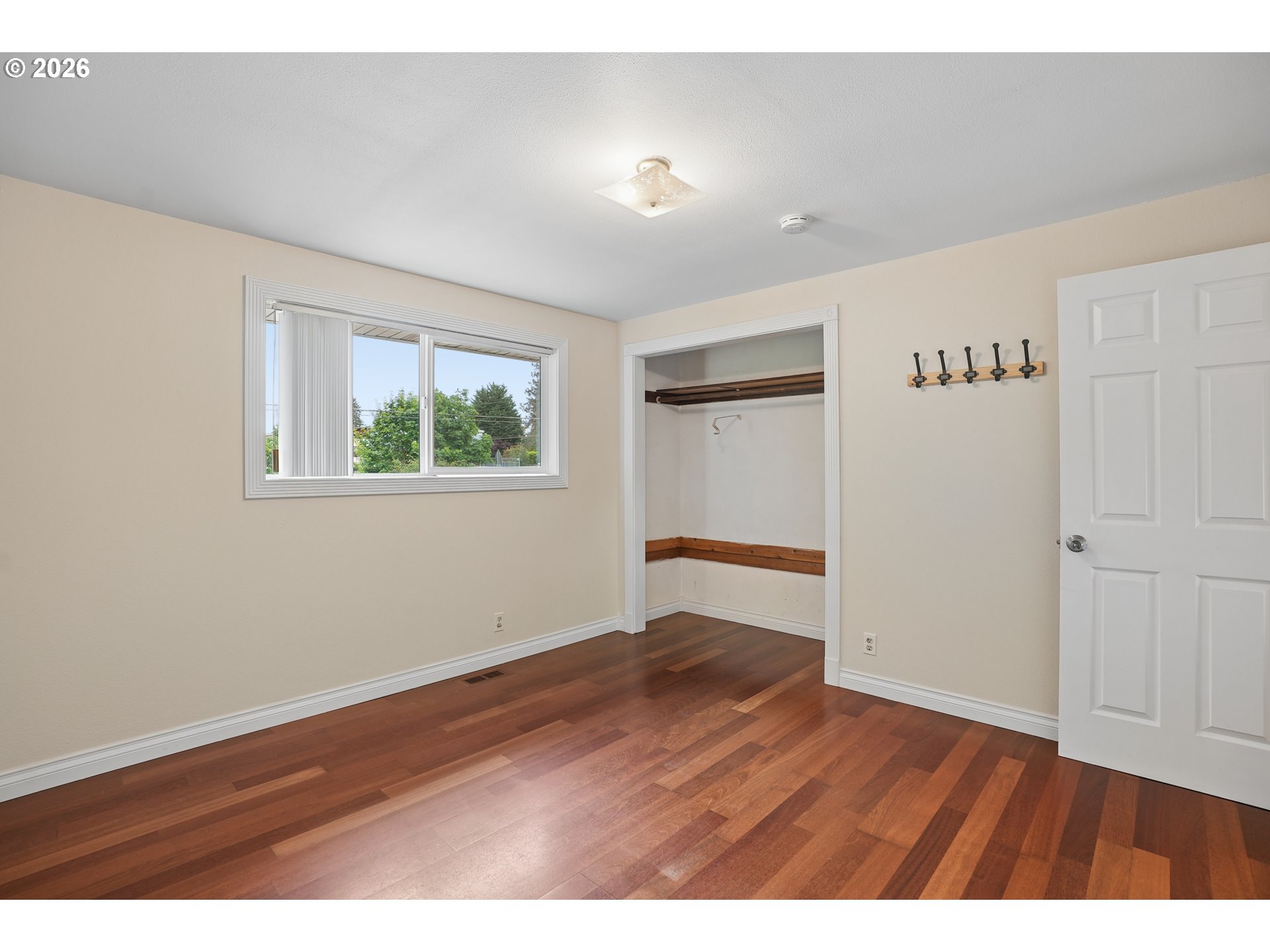 992 South South End Road Oregon City, OR 97045 - Photo 23 of 38 a view of an empty room with wooden floor and a window