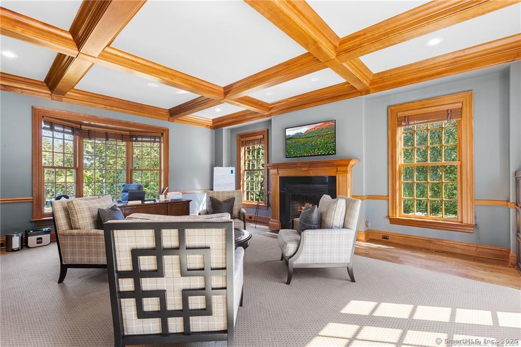 64 Old Redding Road Weston, CT 06883 - Photo 14 of 38 a living room with furniture a fireplace and a floor to ceiling window