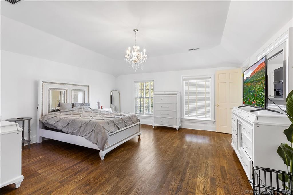 64 Old Redding Road Weston, CT 06883 - Photo 22 of 38 a bedroom with a large bed a flat tv screen and dresser