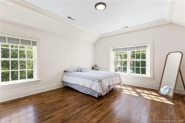 a spacious bedroom with a bed and a large window