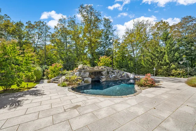 a backyard of a house with table and chairs
