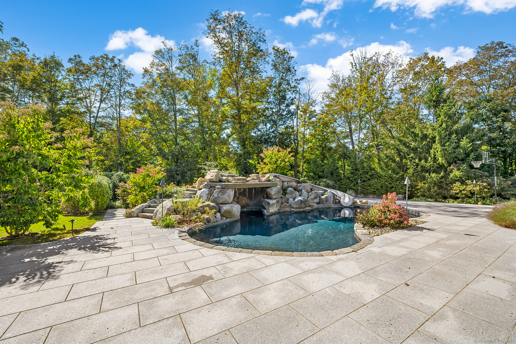 64 Old Redding Road Weston, CT 06883 - Photo 30 of 38 a backyard of a house with table and chairs