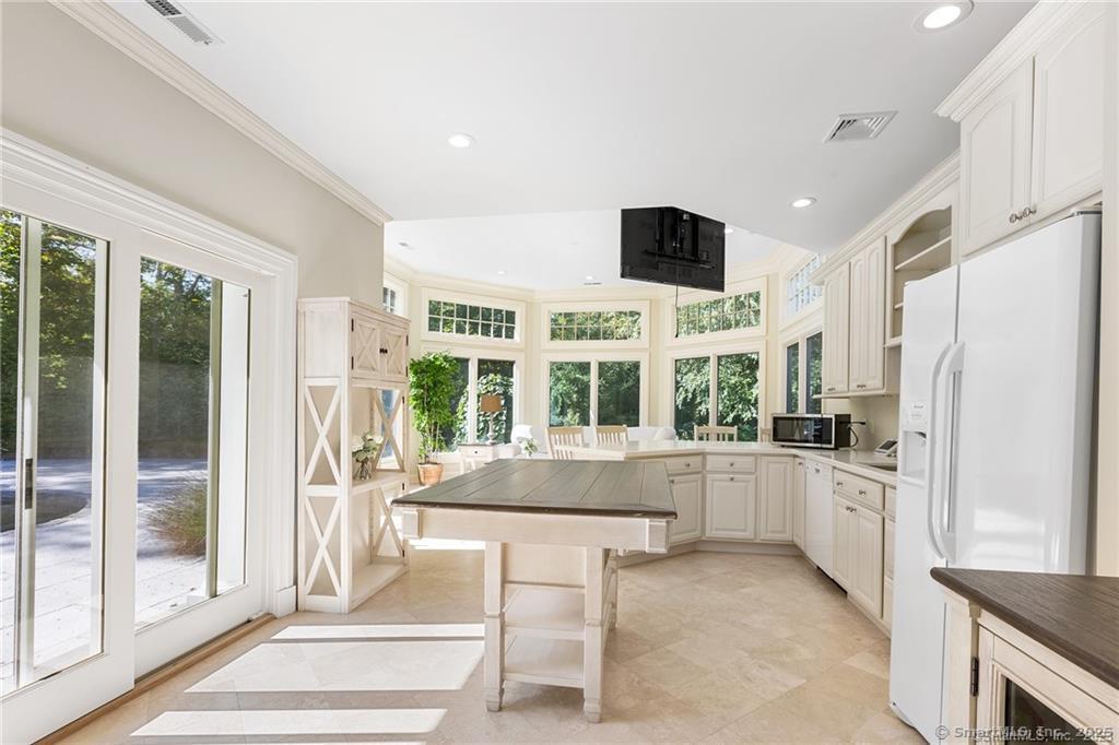 64 Old Redding Road Weston, CT 06883 - Photo 34 of 38 a kitchen with stainless steel appliances granite countertop a stove and a refrigerator