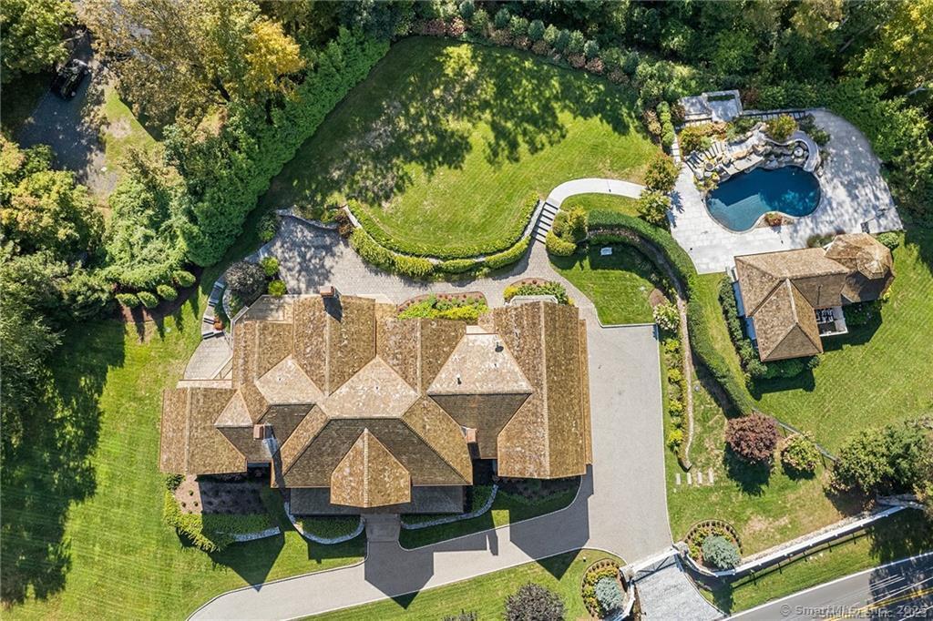 64 Old Redding Road Weston, CT 06883 - Photo 35 of 38 an aerial view of residential house with outdoor space and swimming pool
