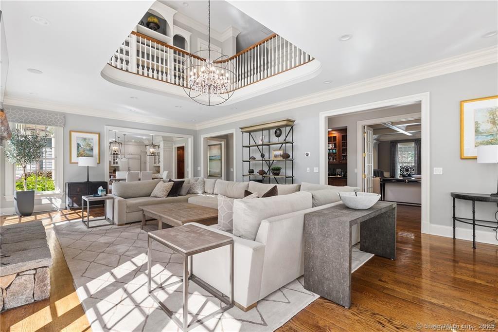 64 Old Redding Road Weston, CT 06883 - Photo 5 of 38 a living room with furniture a chandelier and a dining table