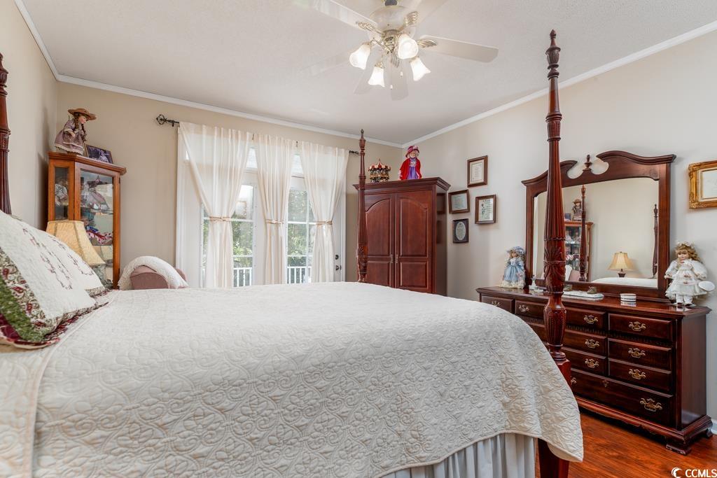 5356 Hamp's Road Nichols, SC 29581 - Photo 11 of 32 Bedroom with ceiling fan, crown molding, and dark