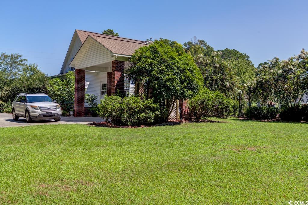 5356 Hamp's Road Nichols, SC 29581 - Photo 28 of 32 View of side of home featuring a lawn