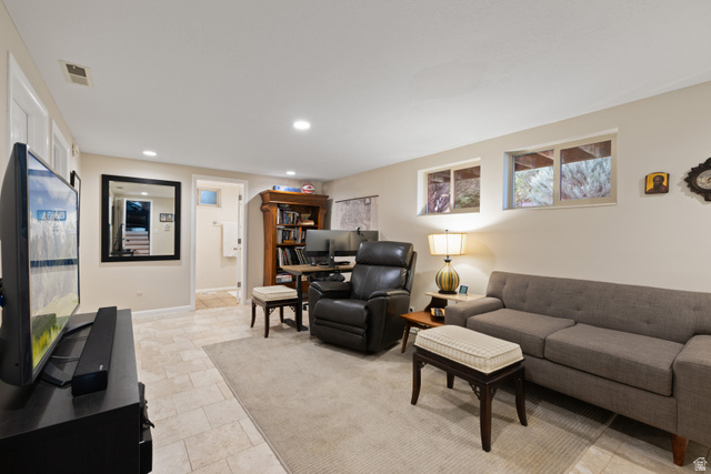 3320 Cherokee Lane Provo, UT 84604 - Photo 31 of 52 Recessed lighting illuminates this living space featuring light-toned tile flooring, a built-in wooden bookcase, and two visible windows